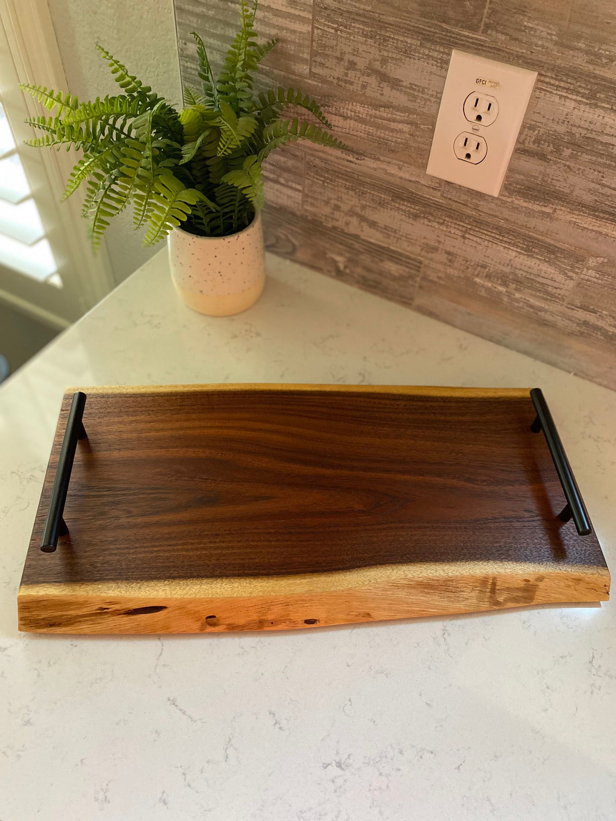 Medium live edge charcuterie board with round handles, side view