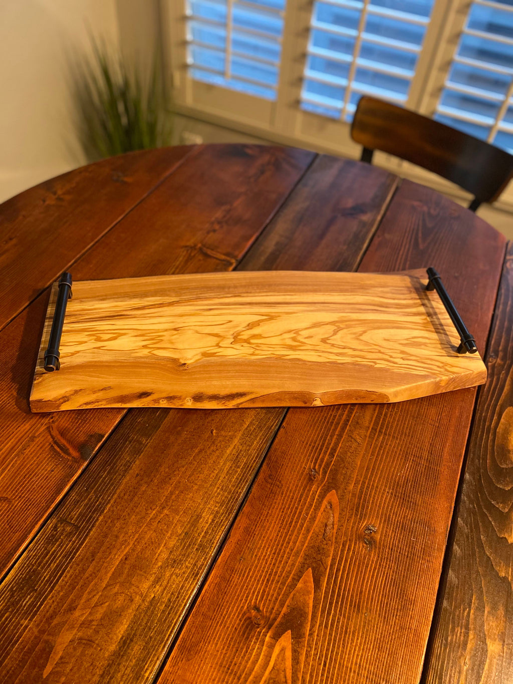 Live edge charcuterie board with enhanced round handles and natural grain