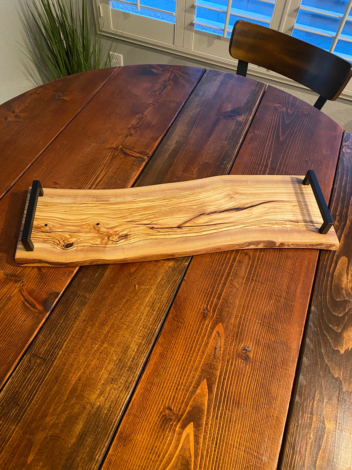 Live edge charcuterie board with square handles and natural grain